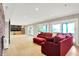 Bright living room with wood floors, a comfortable red sectional sofa, and access to a kitchenette at 22 Point Ln, Arcadia, IN 46030