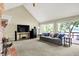 Bright living room featuring a vaulted ceiling, fireplace, and a view of the backyard through sliding glass doors at 22 Point Ln, Arcadia, IN 46030