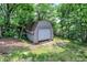 Quaint outbuilding nestled among trees with a single garage door at 22 Point Ln, Arcadia, IN 46030