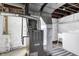 Utility area in basement with exposed ductwork, concrete floor, and washer at 2702 N Talbott St, Indianapolis, IN 46205