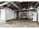 Unfinished basement with water heater, exposed ductwork, and concrete floor at 2702 N Talbott St, Indianapolis, IN 46205