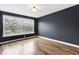 Cozy bedroom featuring hardwood floors, a window, and accent wall at 2702 N Talbott St, Indianapolis, IN 46205
