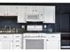 The kitchen features stainless steel appliances, and white cabinets at 2702 N Talbott St, Indianapolis, IN 46205