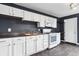 Kitchen featuring white cabinets, stainless steel sink, and modern appliances at 2702 N Talbott St, Indianapolis, IN 46205