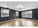 Bright living room featuring three large windows and decorative lighting at 2702 N Talbott St, Indianapolis, IN 46205