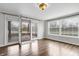 Bright living room with hardwood floors and a sliding glass door to a patio at 2702 N Talbott St, Indianapolis, IN 46205
