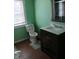 Bright bathroom with updated vanity and fixtures, window, and tile flooring at 3035 Graceland Ave, Indianapolis, IN 46208