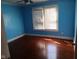 Bedroom featuring hardwood floors, ceiling fan, and bright window at 3035 Graceland Ave, Indianapolis, IN 46208