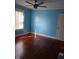 Bedroom with hardwood floors, ceiling fan, and large window providing natural light at 3035 Graceland Ave, Indianapolis, IN 46208
