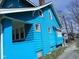 Side view of the blue two-story home, showcasing the brick chimney at 3035 Graceland Ave, Indianapolis, IN 46208
