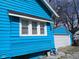 Exterior view showing the light blue siding and white trim, highlighting the garage at 3035 Graceland Ave, Indianapolis, IN 46208