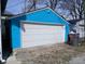 Exterior of a detached garage with a white door and blue siding at 3035 Graceland Ave, Indianapolis, IN 46208