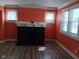 Inviting living room with a decorative fireplace, light-filled windows, and modern floors at 3035 Graceland Ave, Indianapolis, IN 46208