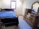 Bedroom featuring a dark wood bed frame and large dresser at 3036 Chase St, Indianapolis, IN 46217