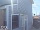 Home exterior featuring light blue siding, white trim, and storm door at 3036 Chase St, Indianapolis, IN 46217