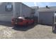 Exterior shot of home showing two-car garage, gravel driveway, and red convertible at 3036 Chase St, Indianapolis, IN 46217