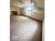 Bright living room featuring a fireplace, vaulted ceilings, and a large arched window at 3036 Chase St, Indianapolis, IN 46217