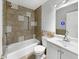 A charming bathroom featuring tile accents and a shower-tub combo with modern fixtures at 3313 Capsella Ln, Indianapolis, IN 46203