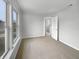 A bright bedroom featuring neutral carpet, white walls and trim, and a large window offering plenty of natural light at 3313 Capsella Ln, Indianapolis, IN 46203