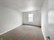A cozy bedroom featuring neutral carpet, white walls and trim, and a window offering lots of natural light at 3313 Capsella Ln, Indianapolis, IN 46203