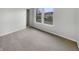Comfortable bedroom featuring neutral walls, carpeted floors, and a sunny window view at 3313 Capsella Ln, Indianapolis, IN 46203