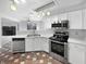 Modern kitchen with stainless steel appliances, white cabinets, and bright pendant lighting at 3313 Capsella Ln, Indianapolis, IN 46203