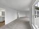 Expansive living room with ample natural light, neutral walls, and cozy carpeting at 3313 Capsella Ln, Indianapolis, IN 46203