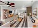 Bright and airy living room featuring hardwood accents, modern furniture, and a large window view at 3313 Capsella Ln, Indianapolis, IN 46203