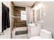 Bathroom featuring a vanity with marble countertop, wood backsplash, and a shower/tub combo at 4910 East 21St St, Indianapolis, IN 46218