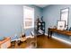 Bedroom featuring hardwood floors, blue walls, and natural light from a window at 4910 East 21St St, Indianapolis, IN 46218