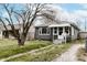 Charming single-story home with a well-manicured lawn and inviting front porch at 4910 East 21St St, Indianapolis, IN 46218