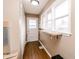 Hallway featuring hardwood floors, natural light, and access to the backyard at 4910 East 21St St, Indianapolis, IN 46218