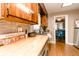 Cozy kitchen featuring wood countertops, stone backsplash, and stainless steel appliances at 4910 East 21St St, Indianapolis, IN 46218