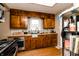 Cozy kitchen featuring wood cabinets, butcher block countertops, gray backsplash, and stainless steel appliances at 4910 East 21St St, Indianapolis, IN 46218