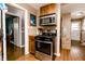 Kitchen with stainless steel oven and stovetop and wood cabinets and laminate flooring at 4910 East 21St St, Indianapolis, IN 46218