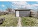 Storage shed featuring grey siding, a white door, and a walkway at 4910 East 21St St, Indianapolis, IN 46218