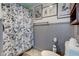 Charming bathroom featuring wainscoting and a floral-patterned shower curtain at 502 E Washington St, Summitville, IN 46070