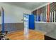 Bright bedroom with hardwood floors and a blue accent door at 502 E Washington St, Summitville, IN 46070