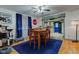 Bright dining room featuring a hardwood floors, a wooden table, and a view into the kitchen at 502 E Washington St, Summitville, IN 46070