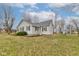 Charming single-story home with light gray siding, dark shutters, and a well-maintained lawn at 502 E Washington St, Summitville, IN 46070