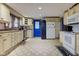 Bright kitchen with white appliances, plenty of cabinet space, and a contrasting blue door at 502 E Washington St, Summitville, IN 46070