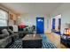 Comfortable living room featuring a cozy sofa, hardwood floors, and a vibrant blue door at 502 E Washington St, Summitville, IN 46070