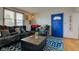 Cozy living room featuring a comfortable sofa, hardwood floors, and a vibrant blue door at 502 E Washington St, Summitville, IN 46070