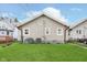 Well-maintained backyard with green grass, neutral siding, and mature trees, perfect for outdoor enjoyment at 518 N Emerson Ave, Indianapolis, IN 46219