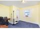 Bright bedroom featuring yellow walls, a window, and neutral carpeting at 518 N Emerson Ave, Indianapolis, IN 46219