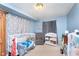 Cozy Bedroom with a crib, changing table, and soft blue walls at 518 N Emerson Ave, Indianapolis, IN 46219