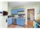 Charming kitchen featuring blue cabinets, stainless steel appliances, and a modern backsplash at 518 N Emerson Ave, Indianapolis, IN 46219