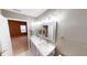 Bathroom with double sinks, bright lighting, large mirror, and contemporary finishes at 5180 Dunewood Way # 57, Avon, IN 46123
