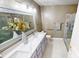 Bathroom with a dual sink vanity, stylish lighting, and a glass-enclosed shower at 5180 Dunewood Way # 57, Avon, IN 46123