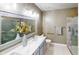Modern bathroom with double vanity, large mirror, updated fixtures, and glass-enclosed shower at 5180 Dunewood Way # 57, Avon, IN 46123